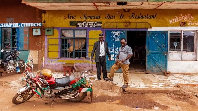 two people posing behind a motorbike