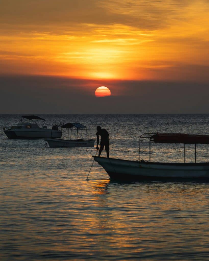 person on boat at sunset in zanzibar